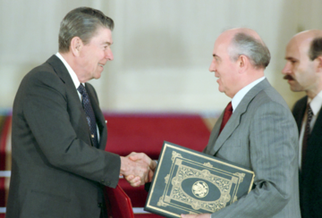 President Ronald Reagan shakes hands with Mikhail Gorbachev.